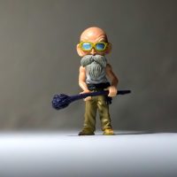 第一动漫网主编沈砚坐在堆满动画设定集与便签的办公桌前，正对照双屏逐条审校作品字段，台灯下摊开的笔记本写满了修订标记